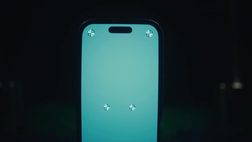 Smartphone with the screen lit up resting on a stand