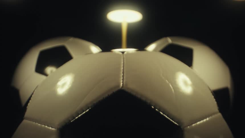 The lamp is shining on the soccer balls