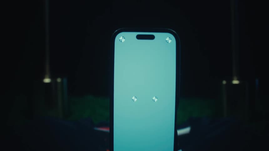 Upright phone displays blue screen with markers over usathemed fabric