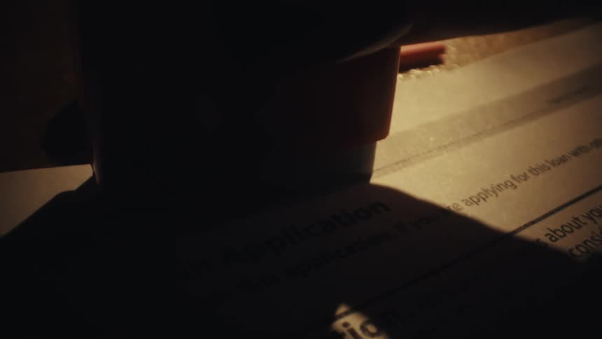 A person stamping a form