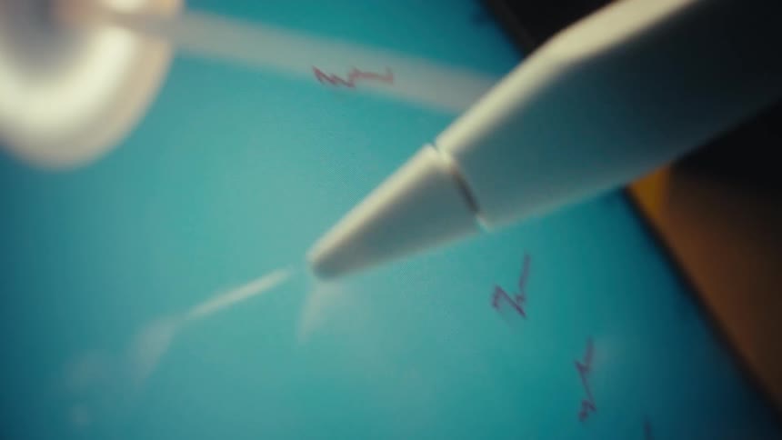 Digital pen touching a screen with red line graphs on a blue background