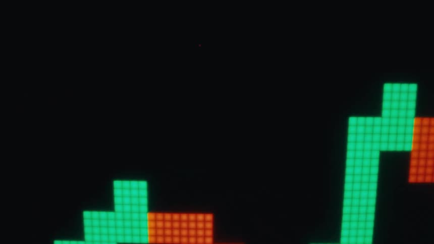 A blockdropping puzzle game appears on a dark screen with brightly colored boxes including green red and yellow stacking and shifting as they fall