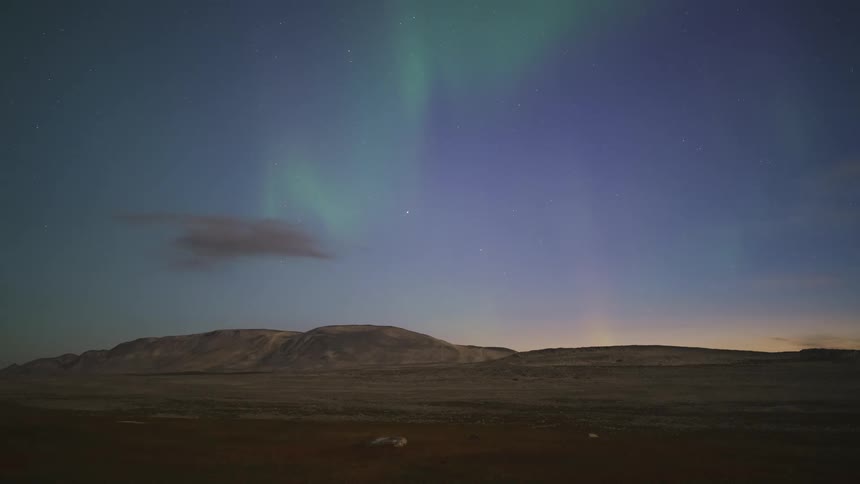A view of some aurora over a mountain