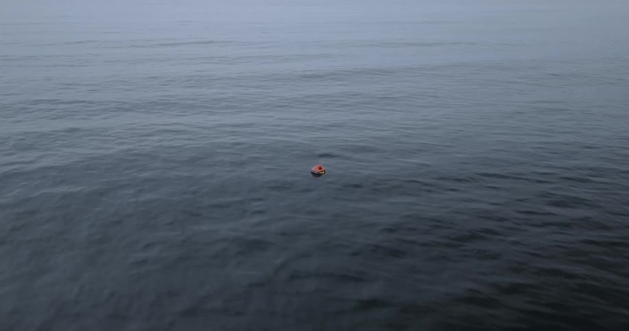 The rescue boat floats on the vast ocean with waves rolling by