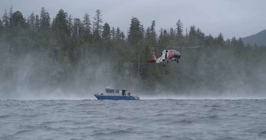 The rescue helicopter is hovering above the boat
