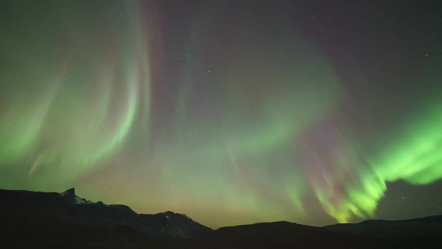 The northern lights flash around the sky at night