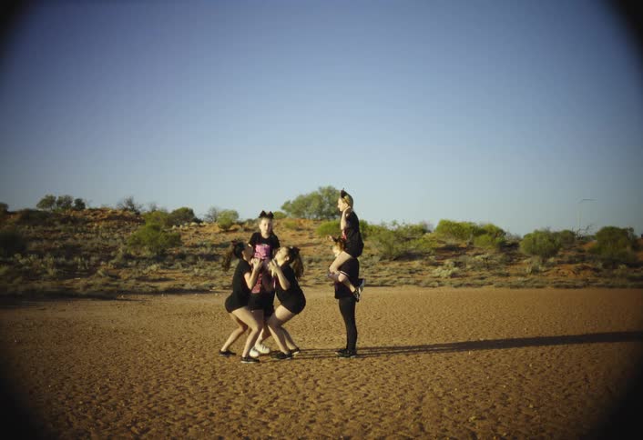 Cheer squad performs a routine on the sands during the daytime