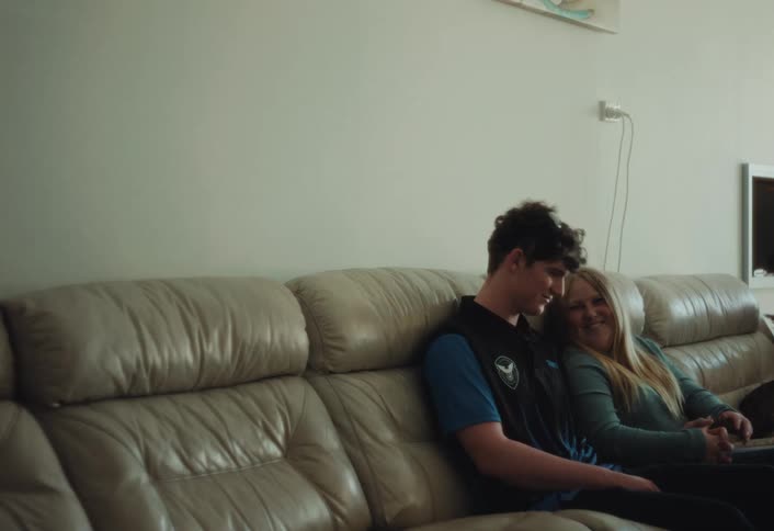 A man and woman cuddling on a couch