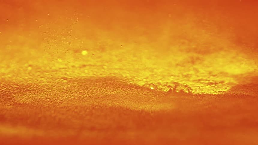 An orangehued textured surface with a subtle gradient the background is a warm glowing orange with small evenly spaced specks