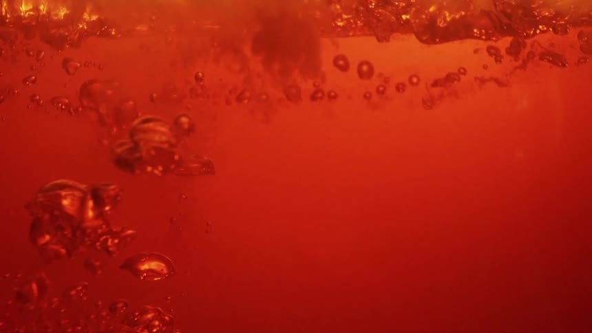 Bubbles rise underwater as the surrounding water shifts to a red tint