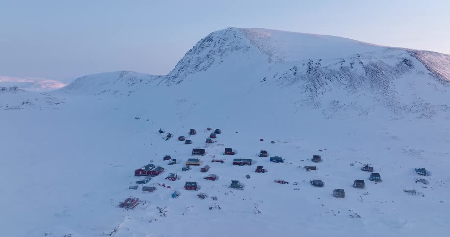 Snowy mountain towers over a rural town on a winter day