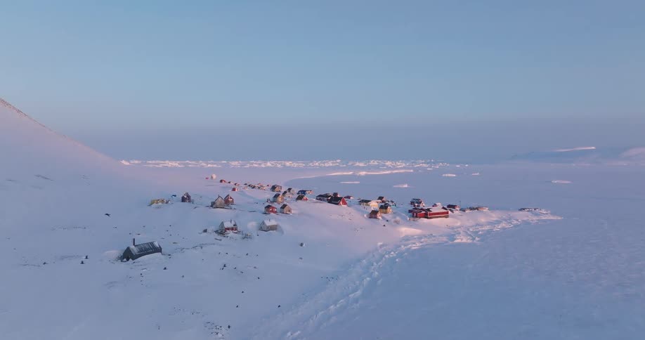 An aerial view of a snow covered mountain area