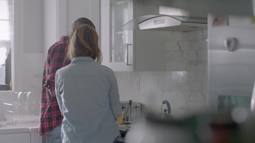 A man and woman cook in a kitchen