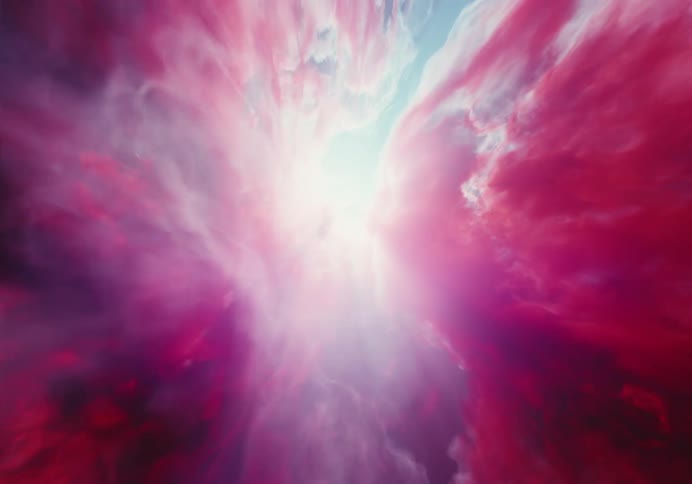 Moving through bright pink clouds to the sun shining through white clouds in a blue sky