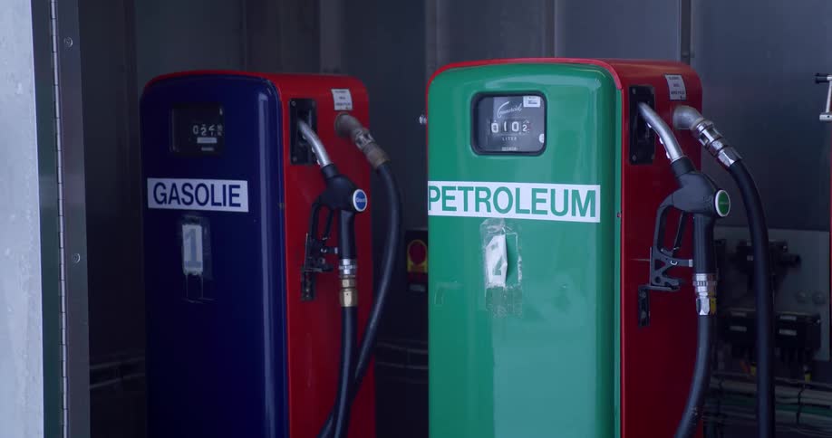 There are two distinct lines of text displayed on labels attached to the vintage fuel pumpsgasolie this label is on the blue pump on the left in dutch gasolie typically refers to diesel fuelpetroleum this label is on the green pump on the right t