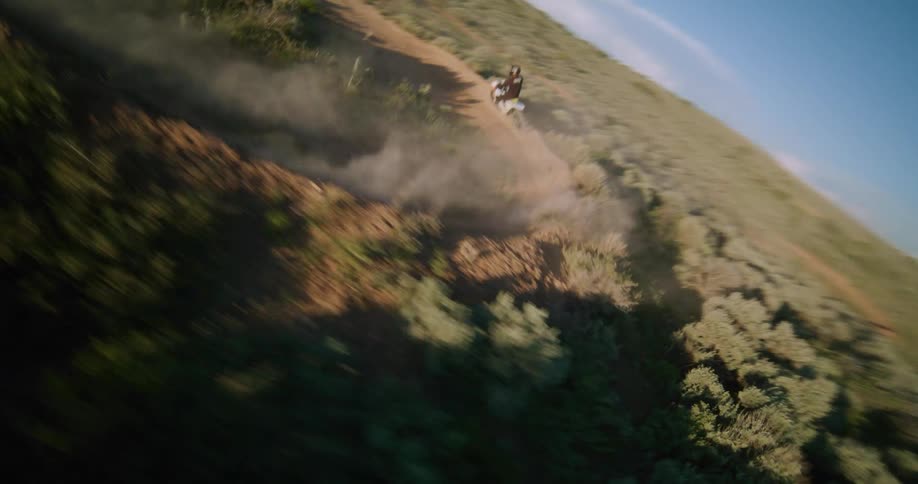 A person riding a dirt bike down trails