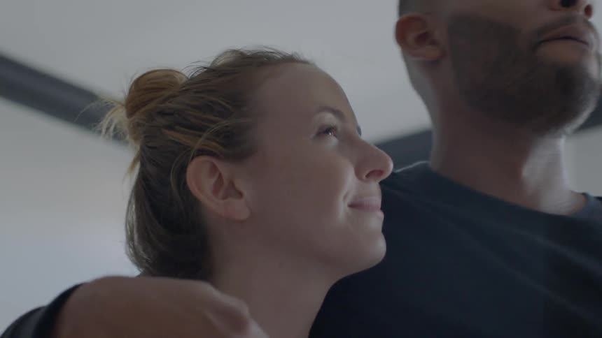 A man and woman hug and kiss