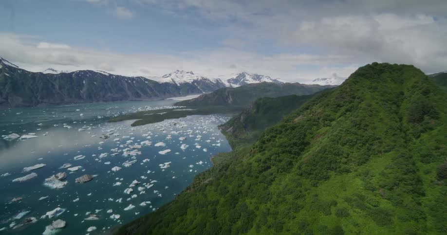 Broken ice melting and floating on the water between mountains