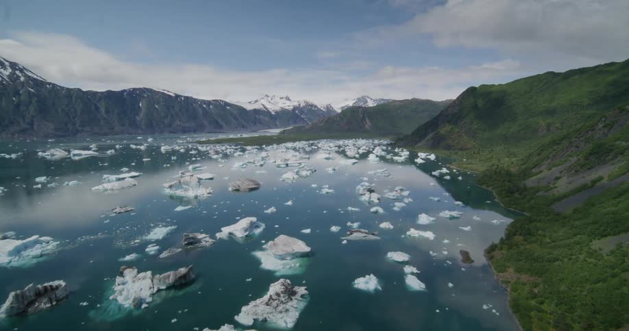 Large pieces broken ice floating on the water between mountains