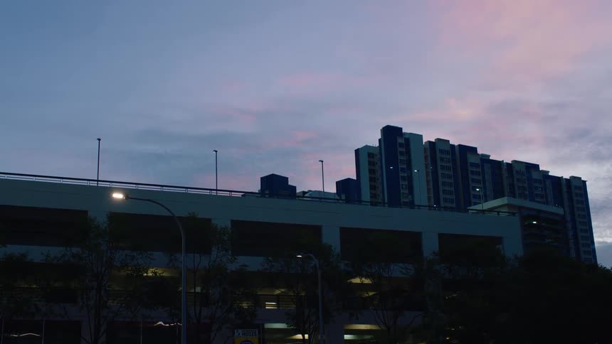 A view of some buildings outdoors at sunset