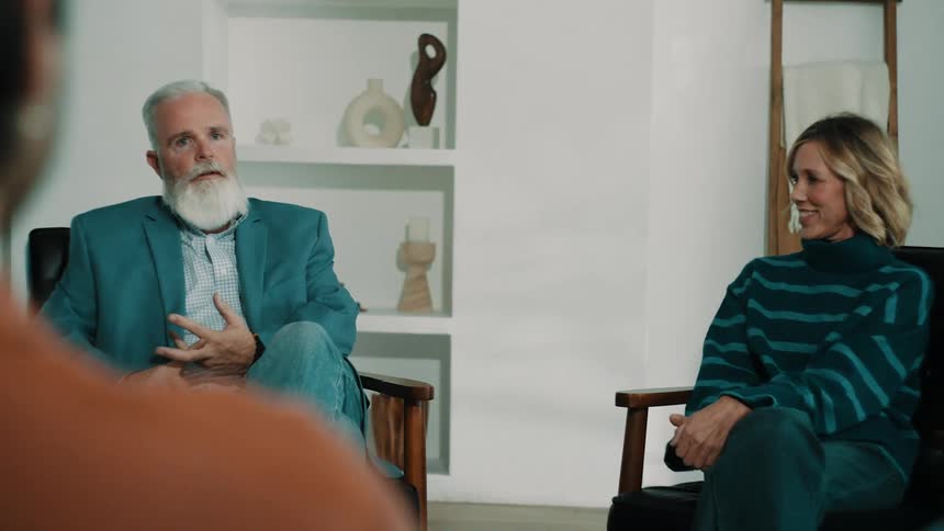 The therapist is talking with patients and they answer