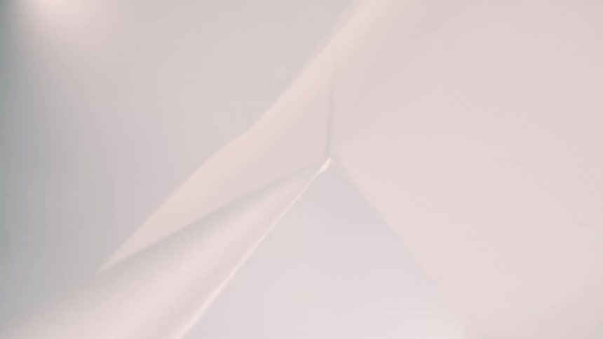 White fabric surfaces forming soft lines under diffused light