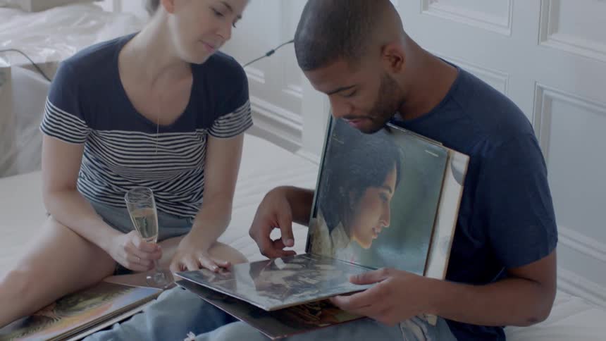 A man and woman sort through vinyl records