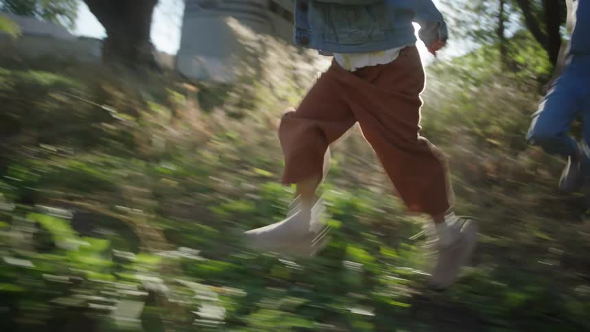 Legs of people running in the woods at dawn