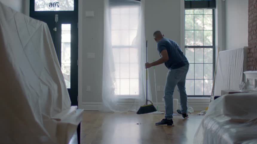 A man is sweeping up a home
