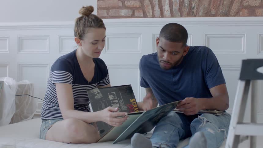 A man and woman look at record albums