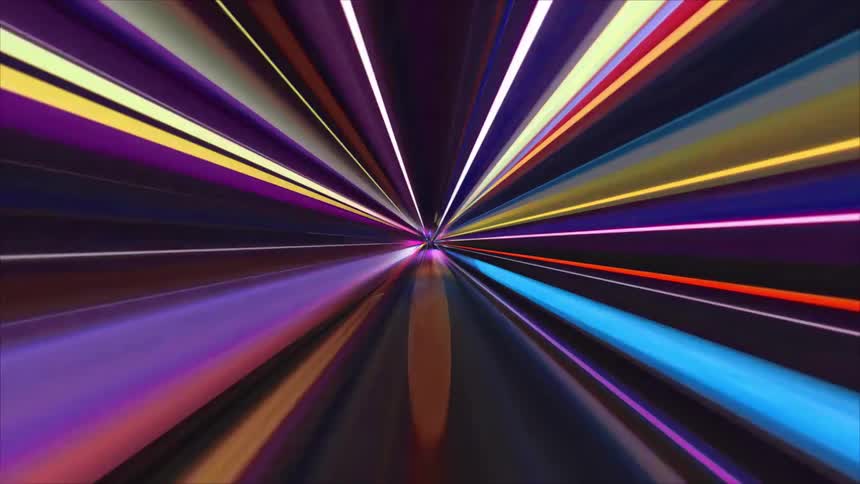 A vibrant abstract animation displays colorful streaks of light radiating from a central point creating a highspeed tunnel effect that moves rapidly toward the viewer through a dark digital void