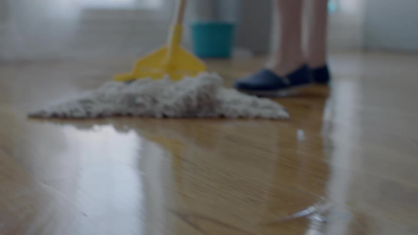A person is mopping the floor