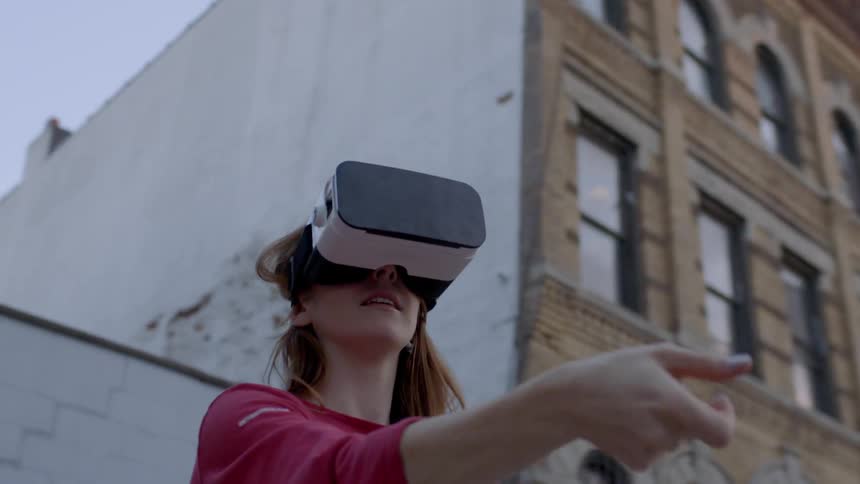 A woman uses vr headset outside
