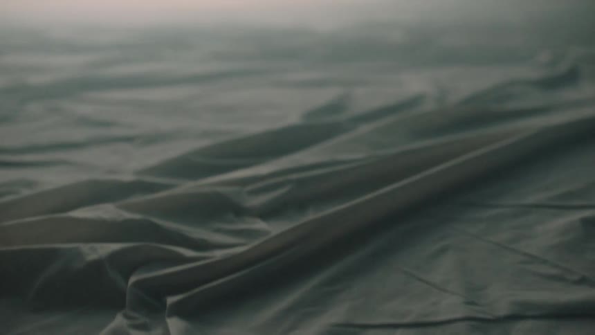 Hazy light shines onto a rumpled piece of fabric
