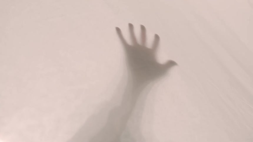 A view of a hand blocked by a sheet