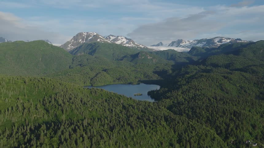 Lake surrounded by a mountain range outdoors during day time