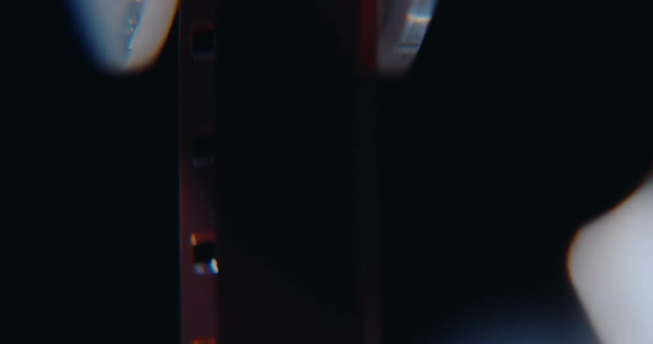 Vertical super 8mm film strip with visible perforations on the left