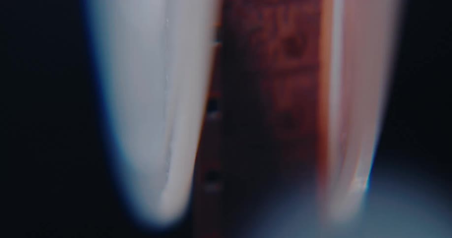 Backlit vertical super 8mm film strip with perforations
