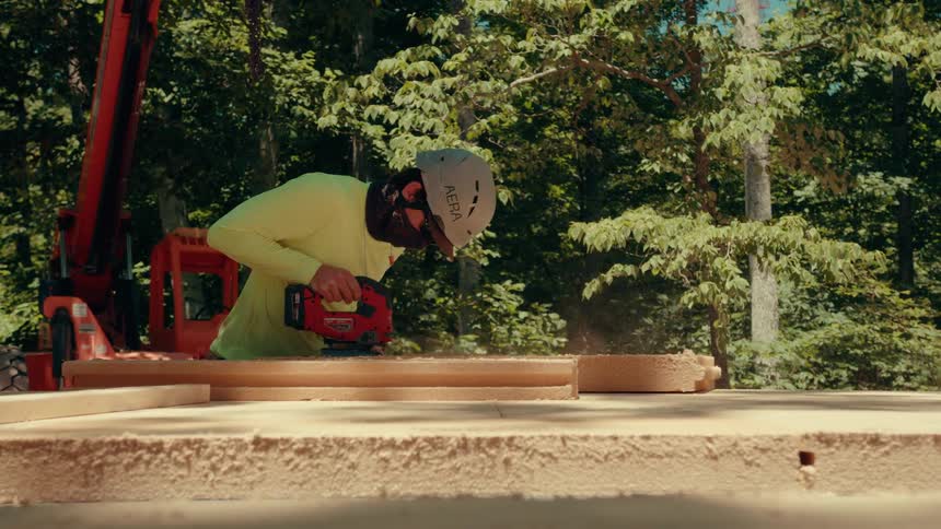 A man cutting wood with a saw