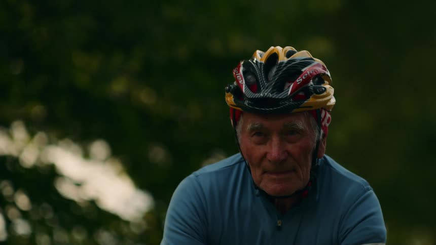 Man wears a cycling helmet as he rides his bicycle