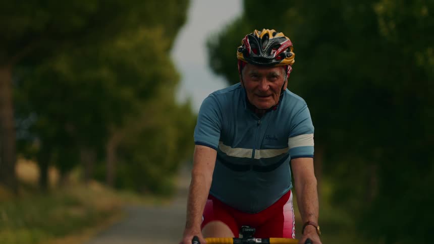 A man riding a bicycle outdoors on a sunny day