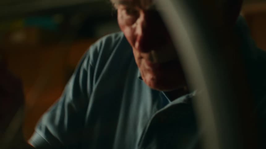 Elderly man working on a bicycle wheel