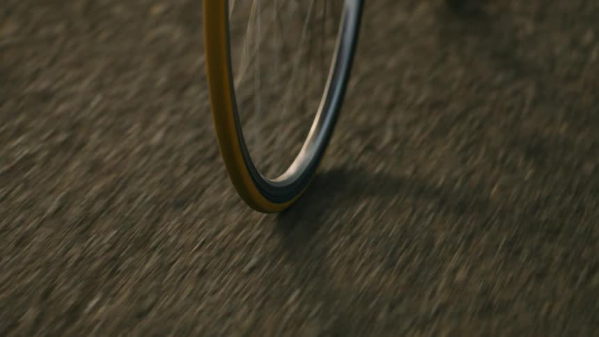 Bicycle wheel rolls across the road as it travels