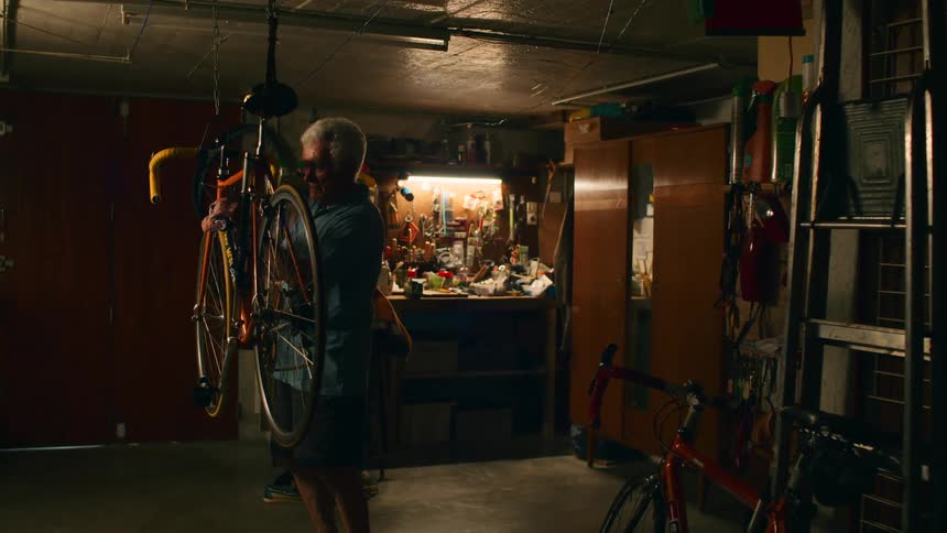 A man working on a bicycle in his garage