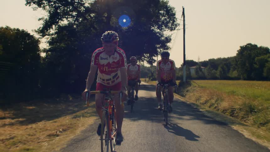 Then men are cycling on the trail on a sunny day