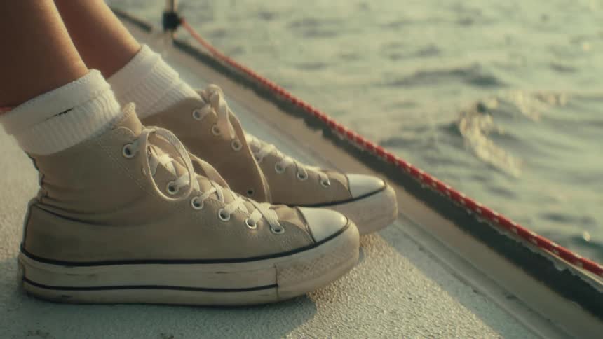 The woman taps her shoes on the boat