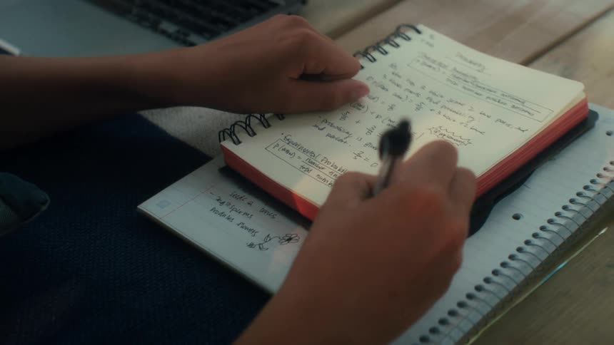 Boy writing in a notebook