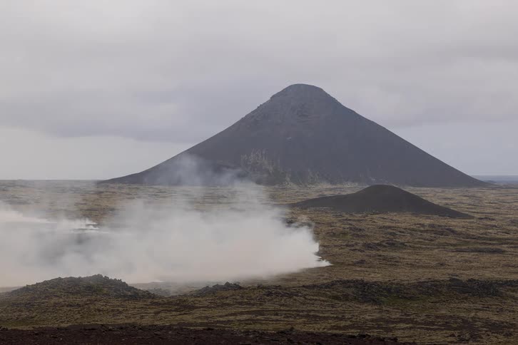 Steam rises from the geyser