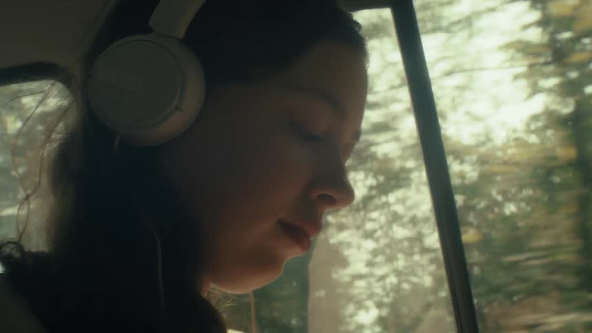 A portrait of a girl riding in a car