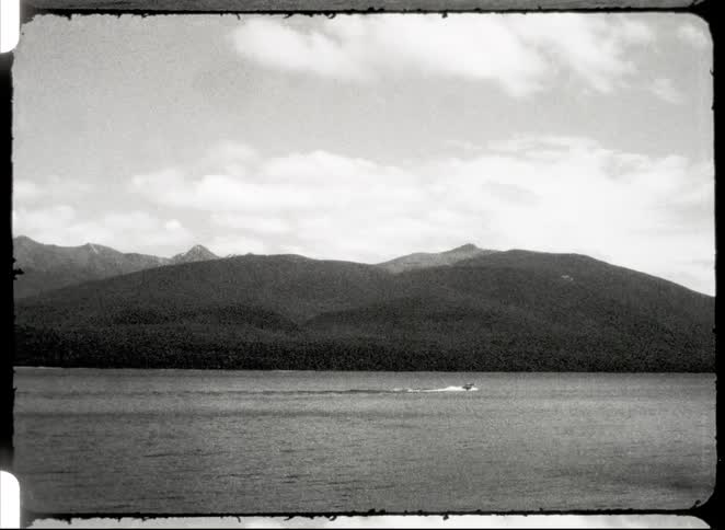 Jet ski moving through the sea with mountains in the background